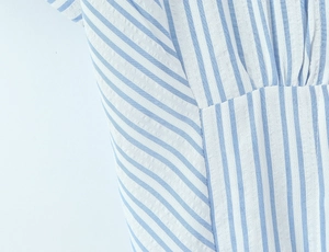 Detail of blue and white striped seersucker fabric with elegant lapel collar and texture