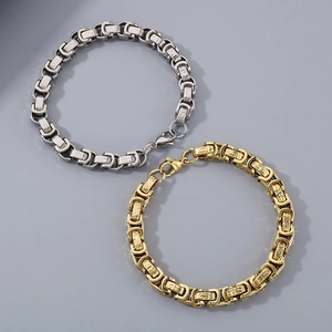 Detail view of 8mm titanium steel curb chain bracelets with Greek fret pattern in gold and silver