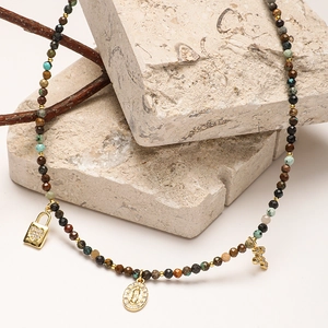 Bohemian natural stone beaded necklace with vintage cross and heart pendants on raw stone