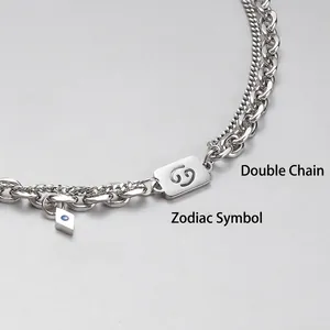 Double-layered silver necklace featuring a Cancer zodiac pendant and blue stone charm