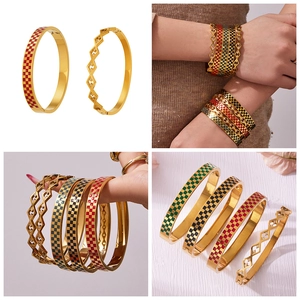 Detail view of gold-plated stainless steel checkerboard enamel bangles in vintage style