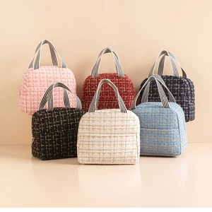 Close-up of elegant tweed insulated lunch bags with chic striped handles in six colors