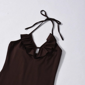 Detail of deep brown halter neck dress with ruffled V-neckline and tie-up design
