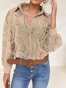 Detail of khaki eyelet embroidery blouse with puff sleeves and button-down collar