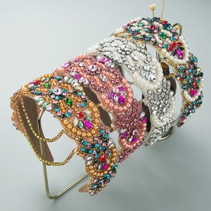 Detail of luxury padded headbands with pearls, colorful rhinestones and gold metal settings