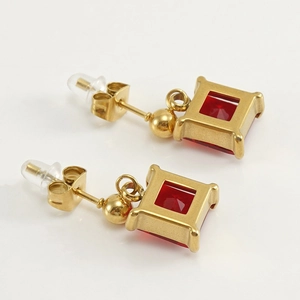 Square gold stainless steel stud earrings featuring a faceted red zircon stone