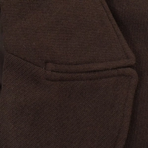 Detail of premium brown wool coat showing high-quality stitching and pocket texture