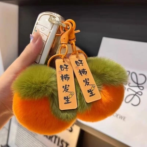 Portachiavi kaki in peluche con targhette portafortuna e pelliccia sintetica arancio