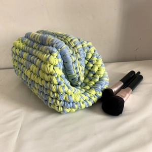 Detail of blue and yellow hand-knitted cloud bag texture with soft fabric yarn