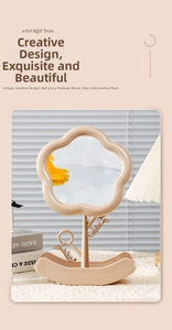 Detail of flower-shaped vanity mirror with jewelry hooks and wavy storage base tray