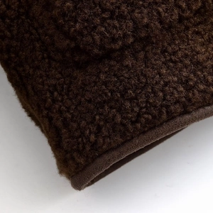 Gros plan macro du tissu polaire marron foncé montrant la texture douce et grainée