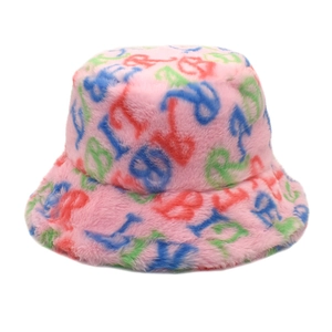 Close-up of pink faux rabbit fur bucket hat with colorful embroidered letters for winter