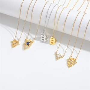 Detailed close-up of gold and silver necklaces with Roman flag and B-letter pendants