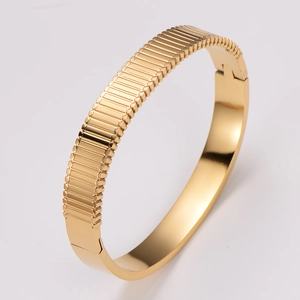 Detail showing the refined horizontal texture of a 304 stainless steel gold bangle