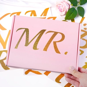 Pink rectangular gift box featuring a sparkling gold glitter MR. lettering design