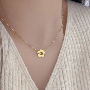 French style 925 sterling silver flower pendant necklace worn over a white sweater