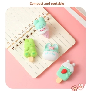 Close-up of cute rabbit dessert erasers including ice cream and sundae shapes on notebook