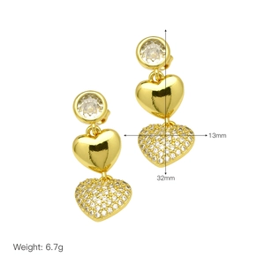 Detail view of 18k gold heart earrings with size specifications and crystal accents
