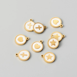 Flat lay of gold stainless steel shell pendants with heart, star, and cross motifs