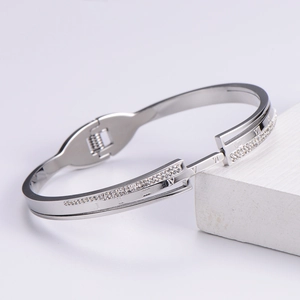 Silver open bangle with Roman numerals and pavé diamonds on geometric pedestal