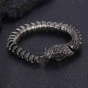Close-up of vintage dragon bone bracelet with green eyes and detailed scales