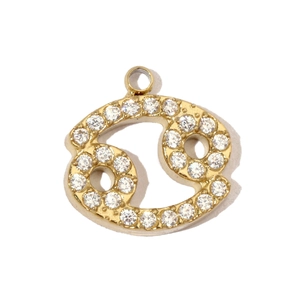 Macro view of gold-plated Cancer zodiac pendant with hand-set cubic zirconia crystals