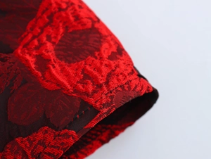 Macro shot of sweet floral jacquard fabric details and flutter sleeve stitching on dress