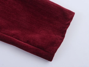 Detailed close-up of burgundy chenille dress sleeve featuring soft corduroy texture