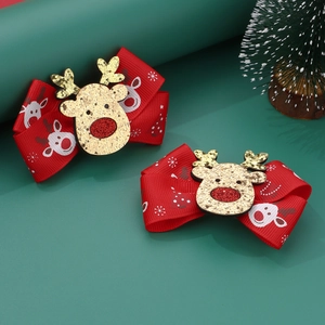 Christmas hair clips set featuring red ribbon bows with gold sequin reindeer on green backdrop