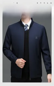 Detail of navy men's jacket with stand collar, metallic zipper and small embroidered logo