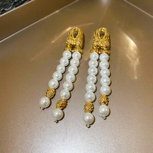 Elegant gold double tassel drop earrings with white pearls in vintage geometric style
