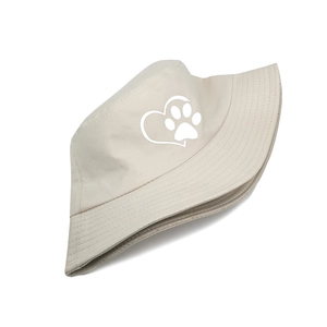 Detail of beige canvas bucket hat with white heart and animal paw print embroidery