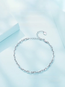 Close-up of a 3mm S925 sterling silver rectangle link chain with a tiny heart charm