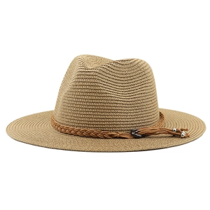 Close-up of straw fedora with brown woven leather band, metal buckle and silver tassels