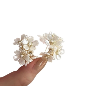 Elegant floral cluster stud earrings with vintage pearls and intricate petal design