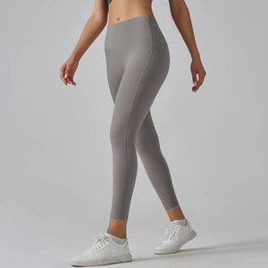 Close-up of high-waisted seamless yoga leggings with functional side pocket and grey matte fabric