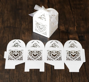 Detailed laser-cut heart favor box with intricate vine patterns and silver ribbon bow