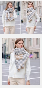 Detail of soft grey and beige plaid scarf with floral print and fringe edges on model