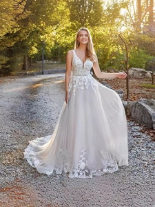 Close-up of elegant V-neck wedding dress featuring intricate lace embroidery and sequins