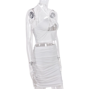 Detailed side view of white halter neck top and ruched bodycon skirt set on mannequin