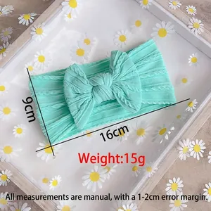 Mint green nylon baby headband with a large bow and cable knit texture 16x9cm size