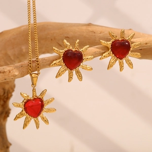18K gold plated stainless steel heart necklace and earring set with red agate on wood