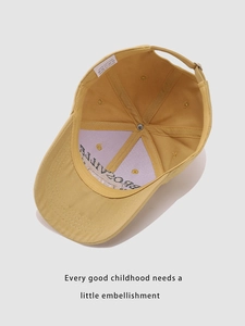 Detail of yellow cotton kids baseball cap showing internal stitching and adjustable metal buckle