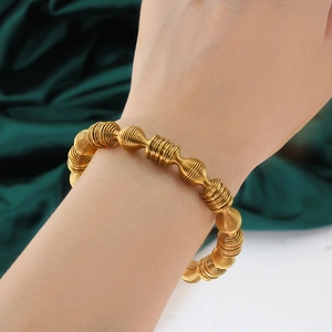 Golden spring spiral metal cuff bracelet for women with elegant retro industrial design