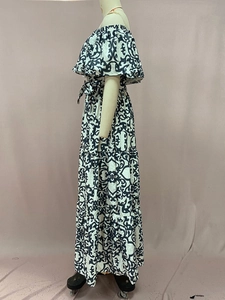 Detail of off-the-shoulder maxi dress with black and white baroque print and tiered hem