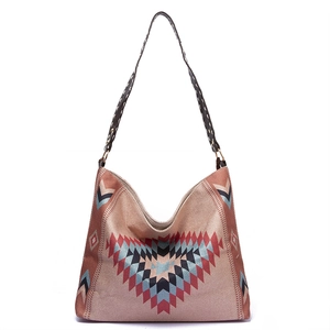 Detail of bohemian tote bag with ethnic geometric prints and brown leather straps