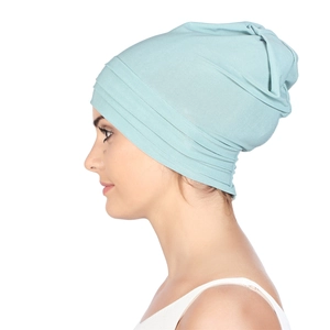 Detailed view of soft mint green pleated turban hat with breathable knit texture