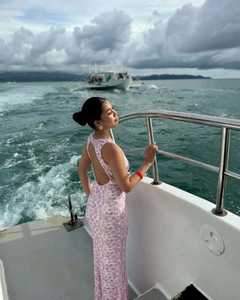 Close-up of the elegant open-back design and pink floral print on the slim-fit maxi dress