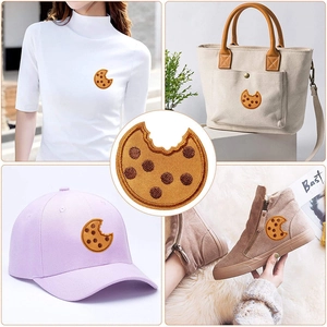 Funny bitten cookie embroidery patch shown on t-shirt, bag, hat, and boots for decoration