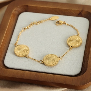Gold plated titanium steel bracelet with three sunburst engraved disc pendants